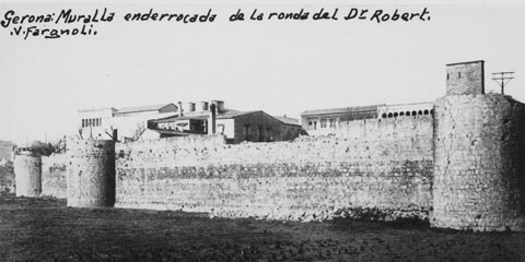 Vista parcial del tram de muralla del Mercadal compresa entre els baluards de Sant Francesc i el de Santa Clara, paral·lel a la ronda del Doctor Robert, posterior ronda Pare Claret. En segon pla, l'edifici de l'hospital de Santa Caterina. 1910-1915