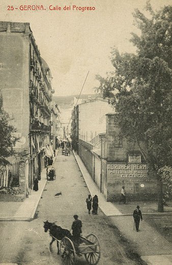 Vista del carrer Nou, a l'altura de la cruïlla amb la Gran Via de Jaume I. A l'esquerra, les cases del projecte Barnoya. A la dreta, un anunci de Adroher Germans pintat al mur. 1920