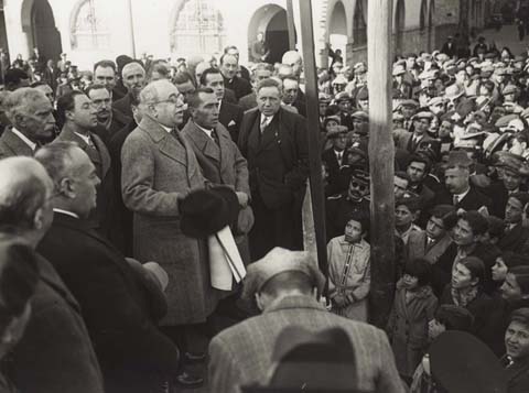 Visita oficial del president de la Generalitat Francesc Macià i del president del govern Manuel Azaña a Girona. Parlament  del president de la República espanyola en la tribuna del baluard de Sant Francesc. Porta a les mans un pergamí dibuixat pe Josep Aguilera. 1931