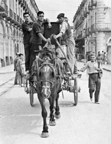 Els traginers Paul&iacute; Font, Pere Font i Joan Dalf&oacute;, traslladant els instruments musicals d'una banda que actu&agrave; a la Festa Major. 1940